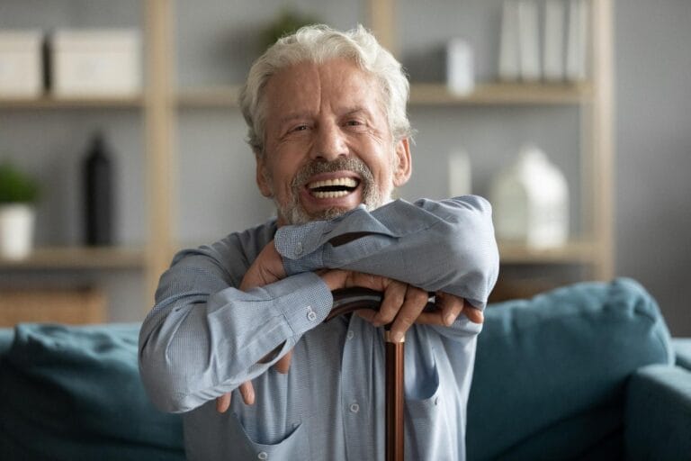 Smiling man with cane.