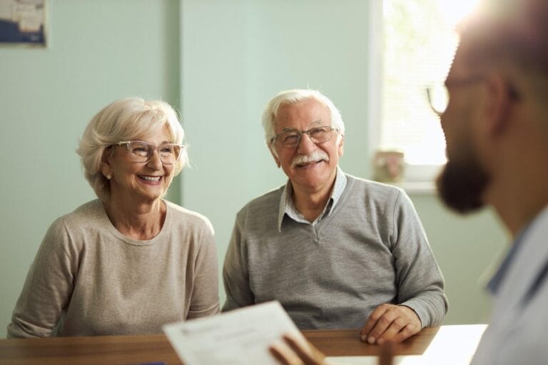 Elderly couple receiving Medicare counseling.